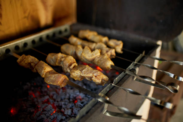istock Summer Barbecue at Home Featuring Kebabs Grilling in a Backyard Grill 2166142653