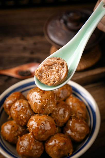 Beef meatballs on wooden table, interior scene with dark background