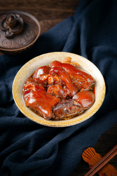 istock Marinated pig's trotters and marinated meat on a dark tabletop in the kitchen indoors 2166144613