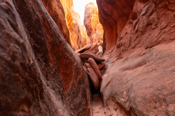 Two large rocks face each other to create a slot canyon inside the Fiery Furnace in Arches National Park near Moab, Utah.