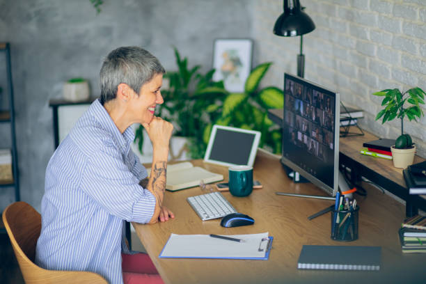 istock Mature woman having a video conference call while working from home 2166152804
