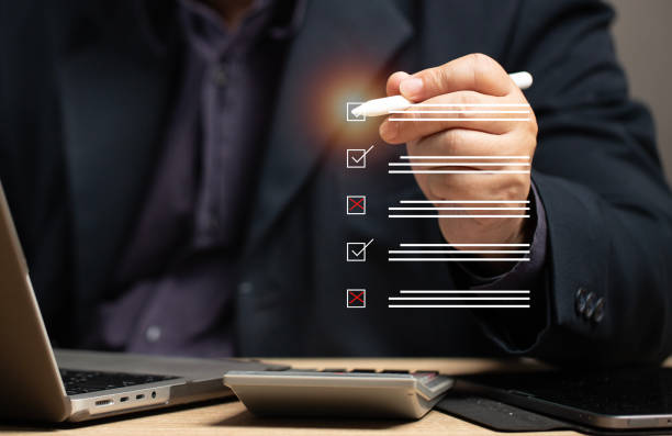istock Marking on checklist box isolated on virtual screen. Checklist concept. Hand holding a pen and checklist isolated with copy space. Questionnaire feedback and check list choice survey form. 2166154976