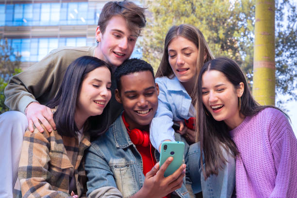 istock Students having fun with mobile phones creating content on social media. 2166155114