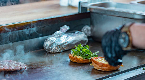istock Making a burger with beef, salad and other ingredients. 2166156239