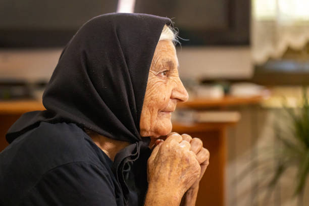 Close up of senior women hand praying at ramadan .
