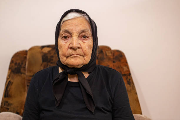 Old woman taking selfie in living room
