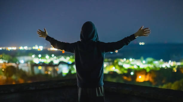istock Happy man silhouette at night city background. 2166169258
