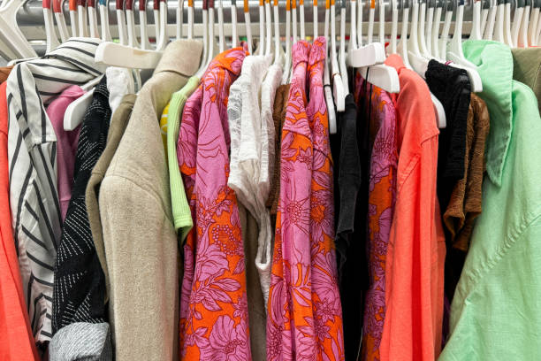 istock brightly colored clothing items, including floral patterns and various textures, hanging neatly on white hangers 2166170160