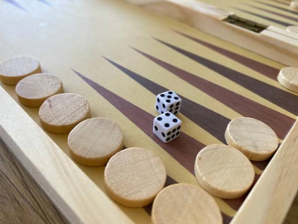 istock Backgammon game. Wooden board with backgammon game pieces with dice 2166171454