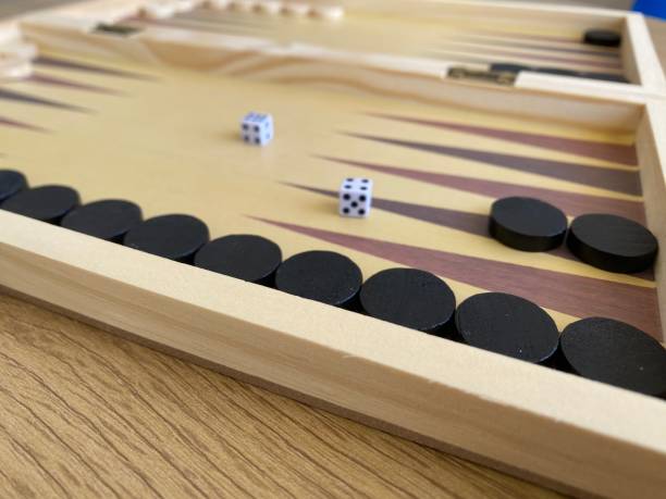 istock Backgammon game. Wooden board with backgammon game pieces with dice 2166171456