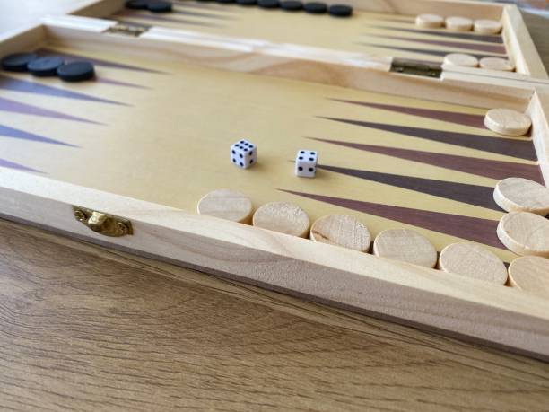 istock Backgammon game. Wooden board with backgammon game pieces with dice 2166171457