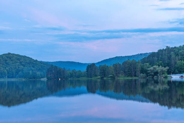 istock Setting sun low light long exposure over mountain lake summer season background image 2166172239