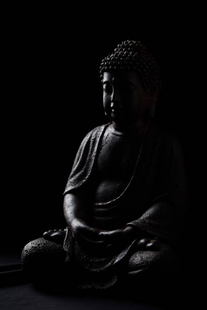 istock Meditating Buddha Statue on dark background. Soft focus. Close up. Copy space. 2166174943