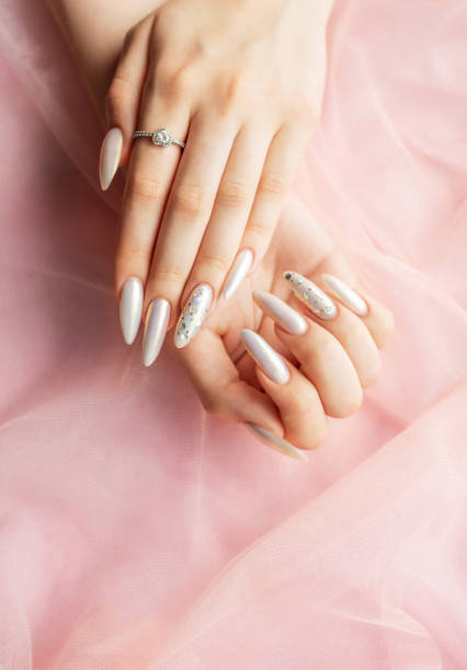 istock Female Hands with beautiful pearl manicure 2166175739