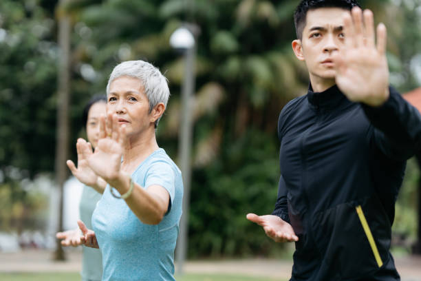 istock Asian people practicing Taichi at public park 2166179657