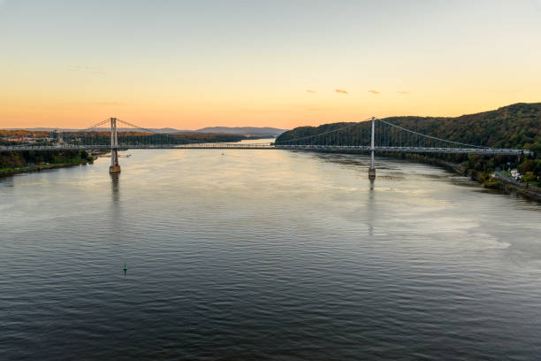 istock Road bridge spanning a large river under clear sky at dusk 2166181777