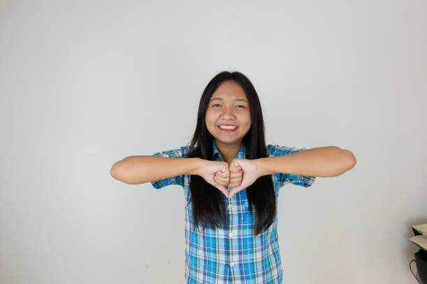 Happy young girl with blue shirt on white background.