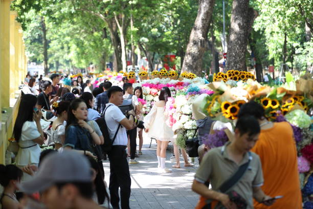 Every autumn, many people flock to Phan Dinh Phung street to take pictures.\n\nHanoi enters early autumn, which is also the time when Phan Dinh Phung street is more crowded than usual when many young people come to check in on one of the most romantic streets in Hanoi. In the early days of autumn, Phan Dinh Phung and Hoang Dieu streets become more bustling. Flower bicycles carry colorful flowers, carrying hope for mothers and sisters who spend many days traveling with flower bicycles, bringing a lot of joy to their eyes. in the spirit of young people