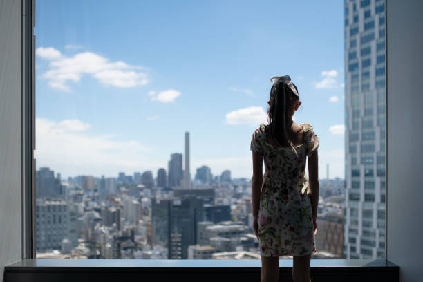 istock Girl looking out the window 2166185443
