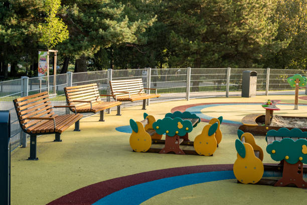 istock Early morning in a serene public park featuring colorful playground structures and empty benches 2166187004