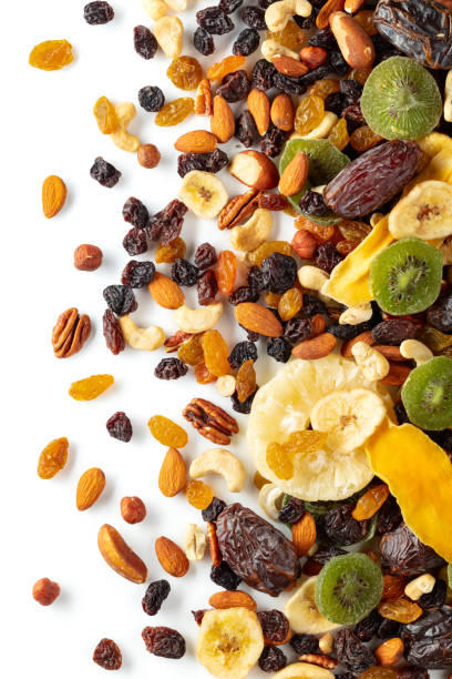 istock Dried tropical fruits, nuts, and raisins isolated on white. 2166187614