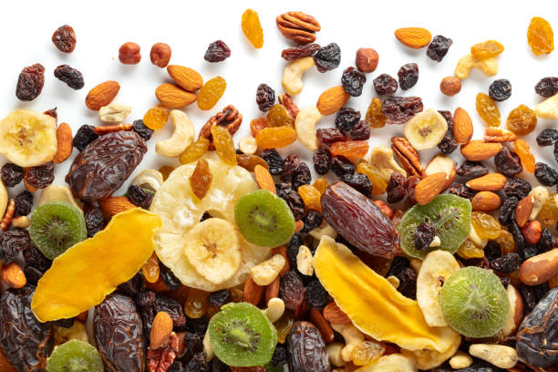istock Dried tropical fruits, nuts, and raisins isolated on white. 2166187619