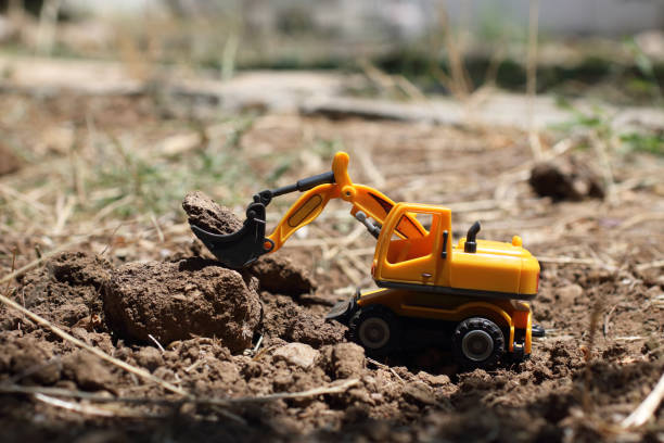 Toy construction machinery working on an excavation