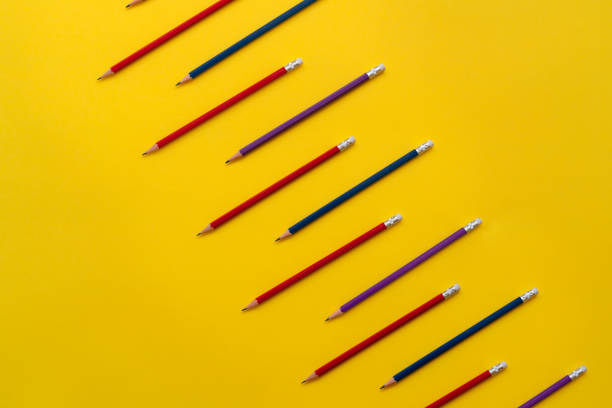 Back to school flat lays on blue background. Blue pencils repetitive flat lay on blue background.