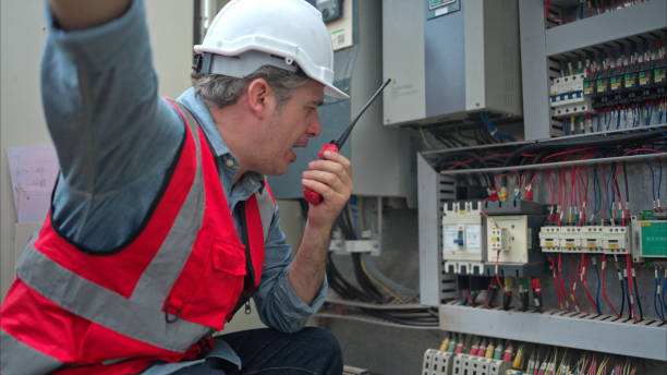 istock Electrical engineer inspects the electrical control board of a crane before putting it to use on a construction site 2166193639