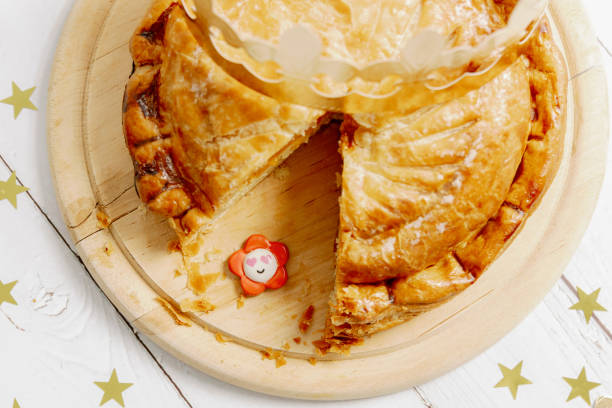 istock One cut royal galette with a crown and a surprise gift on the table. 2166195953
