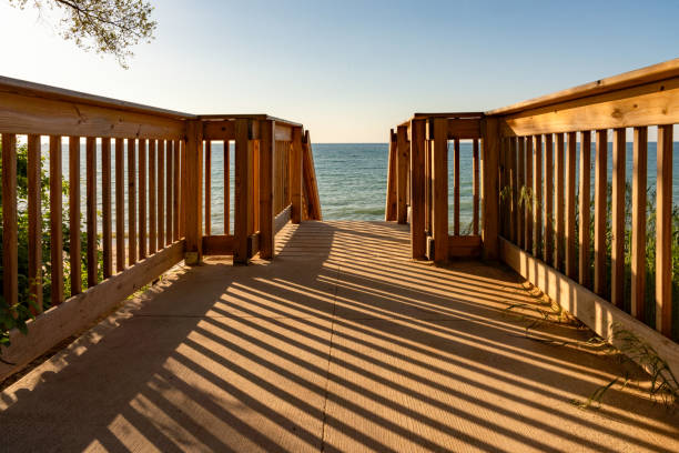 Disabled access walkway at the beach and tranquil sea scene with sailing boats on the horizon