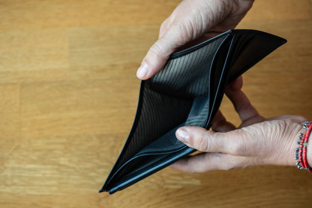 istock A closeup woman hand open an empty wallet 2166199976
