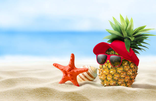 istock Experience a vibrant Tropical Fun moment A delightful Pineapple wearing Sunglasses on a Beach 2166199982