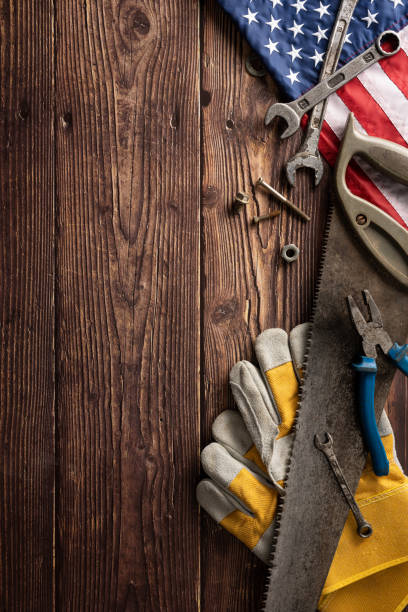 istock Tools and work gloves with the American flag on a vertical wooden background symbolizing Labor Day and hard work 2166202904