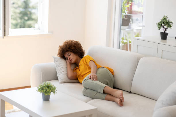istock Young woman sleeping on the couch at home 2166203777