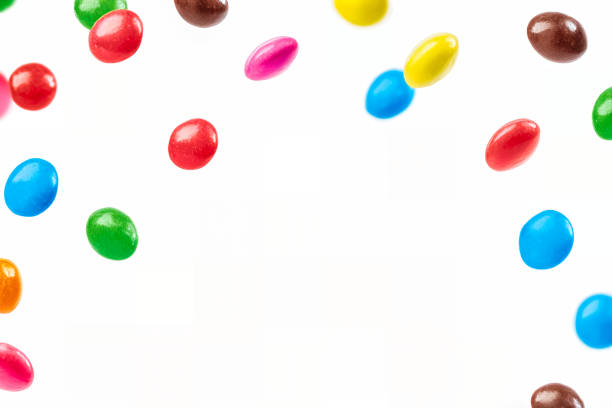 Colorful Rainbow Candies Falling on White Background