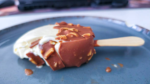 istock A cracked and bitten ice cream with almonds and chocolate coating on a plate 2166208924