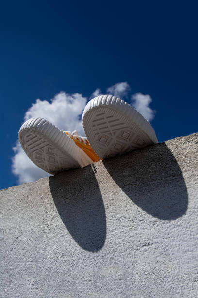 Yellow sneakers against the sky