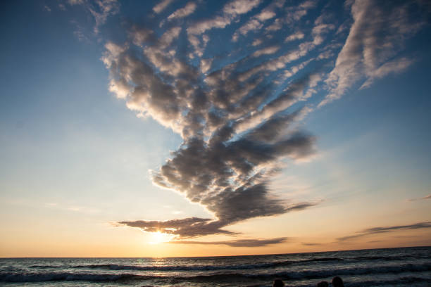 Sunset over the Polish sea. In the sky, fantastic clouds form the shape of a bird.