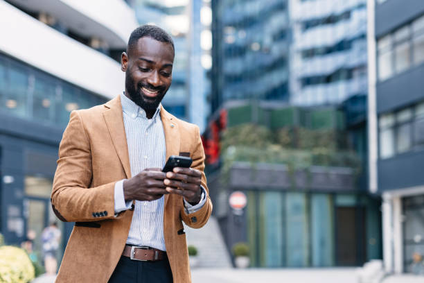 istock Happy professional using smartphone in city district 2166212914