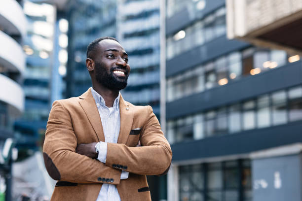 istock Smiling professional man looks ahead in urban setting 2166212933