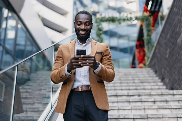 istock Happy professional using phone on city staircase 2166212972
