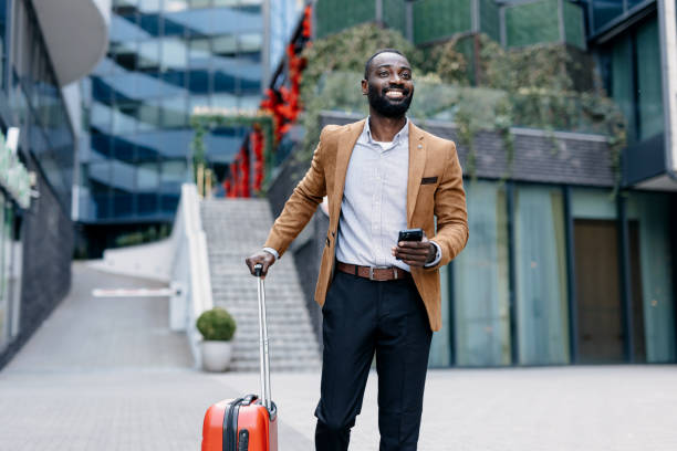 istock Smiling businessman using mobile phone in urban area. 2166213010