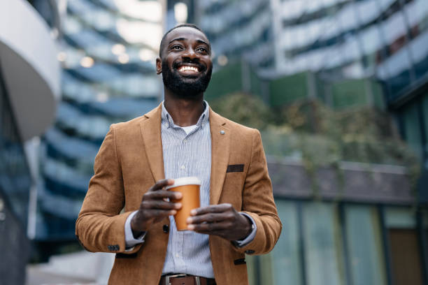 istock Businessman holding coffee cup in urban environment 2166213655