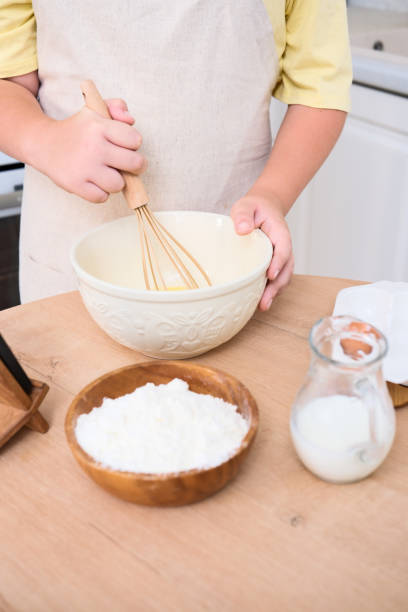 istock A child enthusiastically baking in a cozy kitchen filled with various delicious ingredients 2166215980