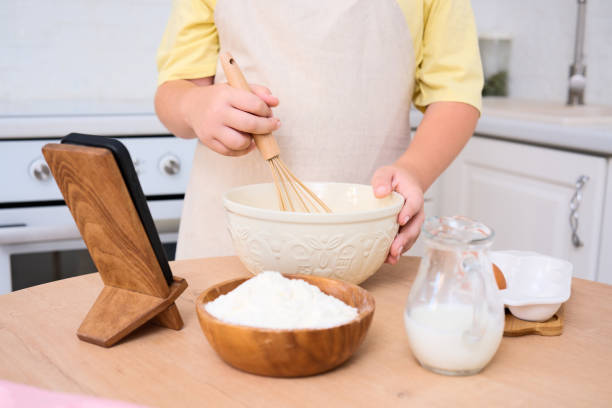 istock A child enthusiastically baking in a cozy kitchen filled with various delicious ingredients 2166216174