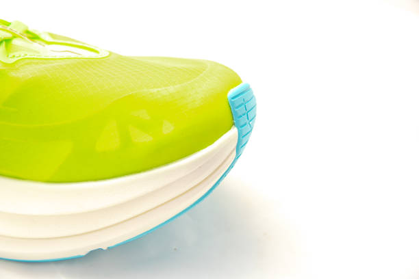 Two pairs of black canvas sneakers with white laces and rubber soles are positioned stylishly on a white background. Perfect for daily use or active outings, these shoes combine comfort and versatility for any casual occasion.