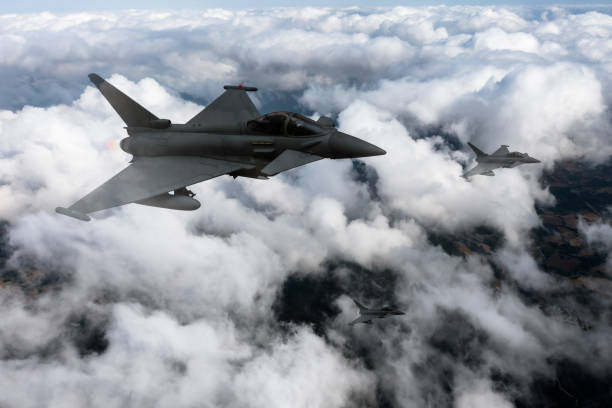 istock Jet aircrafts flying over the clouds. 2166220757