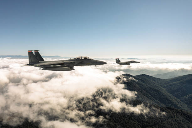 istock Jet aircrafts flying over the clouds. 2166220859