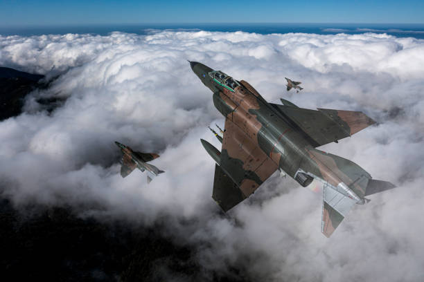 istock Jet aircrafts flying over the clouds. 2166220912